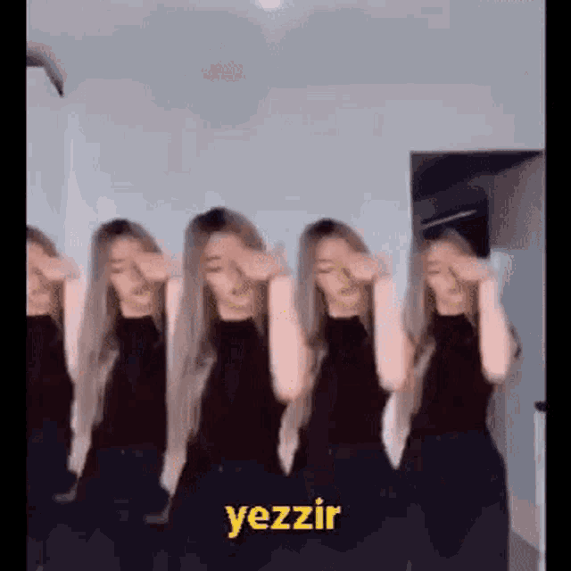 a group of women are standing next to each other in a room and dancing .