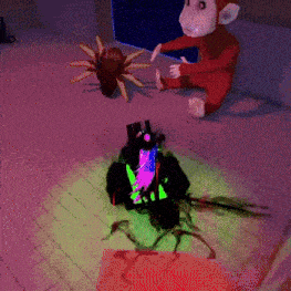 a monkey in a red jumpsuit is sitting next to a glowing object
