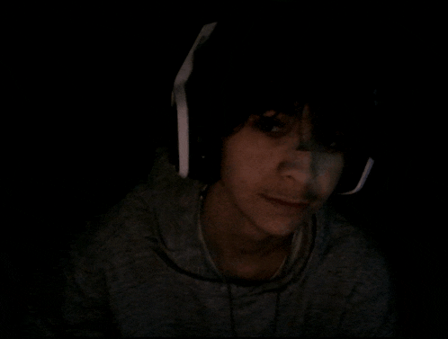 a person wearing headphones is looking at the camera