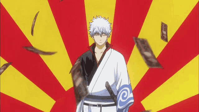 a man in a kimono is standing in front of a red and yellow striped background