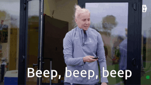 a woman standing in front of a door with the words beep beep beep written below her