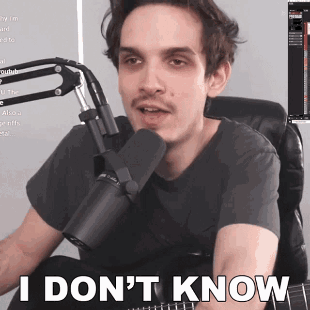 a man sitting in front of a microphone with the words " i don 't know " above him
