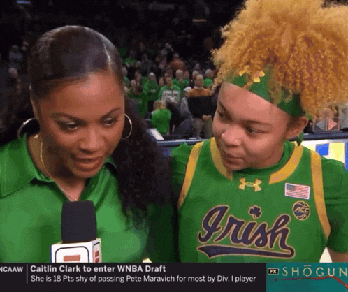 two women wearing green irish jerseys are interviewed