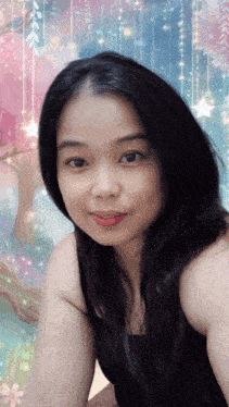 a woman in a black tank top is looking at the camera