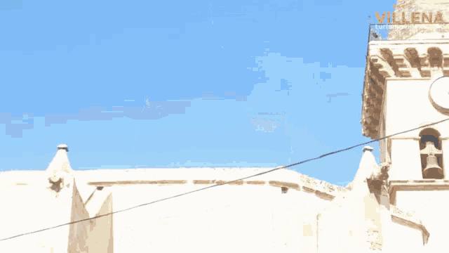 a clock tower with the word villena on the top
