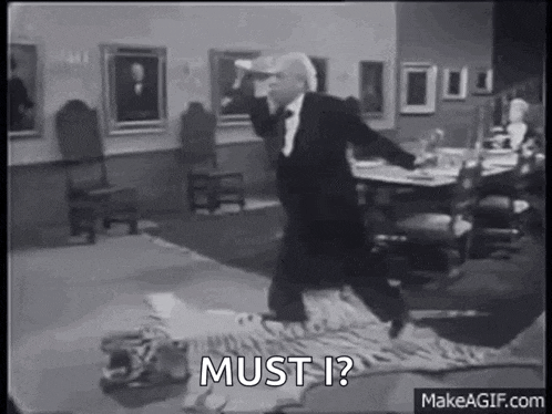 a man in a tuxedo is walking on a tiger rug in a living room .
