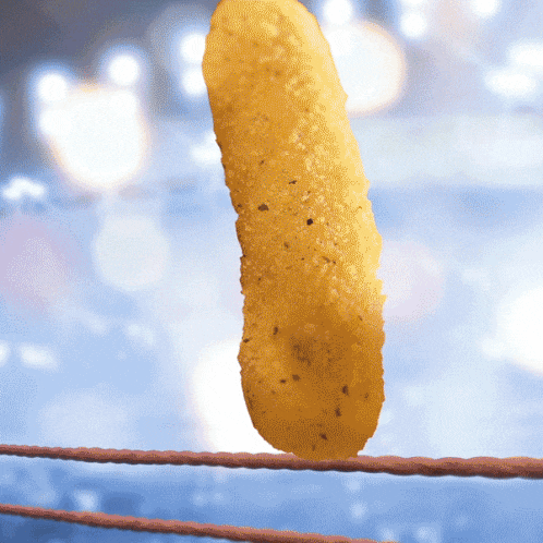 a pickle stick is hanging on a rope in a boxing ring