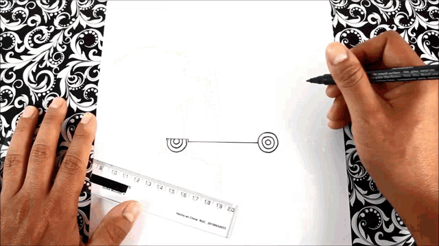 a person is using a ruler and a marker to draw a line