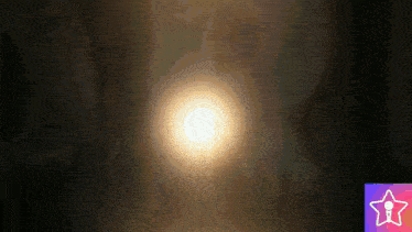 the sun is shining brightly in the dark with a star in the background