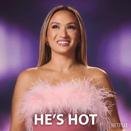 a woman is wearing a pink feathered top and says he 's hot