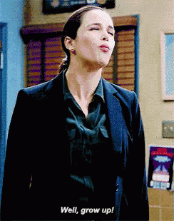 a woman in a suit is saying well grow up .