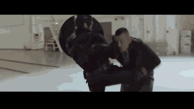 captain america is kicking a man in the face while holding a shield