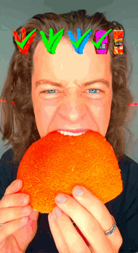 a man with a ring on his finger is eating a hamburger