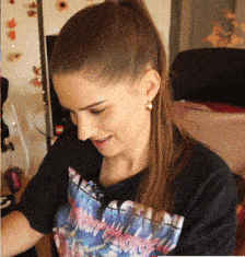 a woman wearing a t-shirt that says ' i love you ' on it is smiling