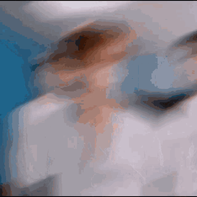 a blurry picture of a person 's face and a blue background