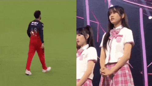 a man walking on a field next to a girl in a plaid skirt .
