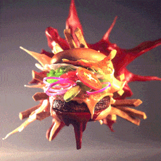 a hamburger is surrounded by french fries and a splash of sauce