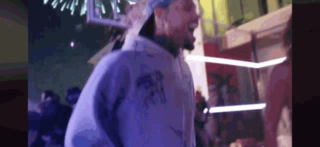 a blurry picture of a man in a purple hoodie