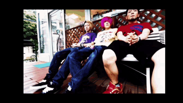 a group of people sitting on a bench with one wearing a shirt that says ' snoop dogg ' on it