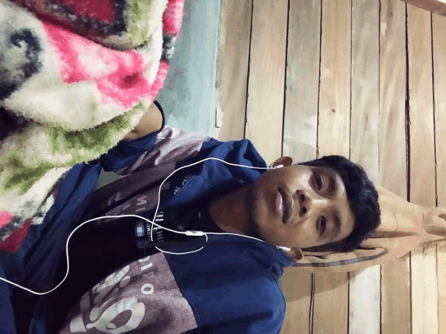 a young man wearing headphones and a shirt that says ' io ' on it