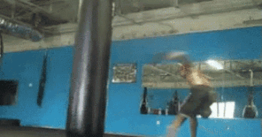 a boxer is hitting a punching bag in front of a mirror