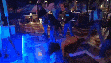 a group of people dancing in a room with a sign that says ufc