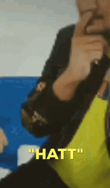 a blurred image of a person with the words " hatt " on the bottom right