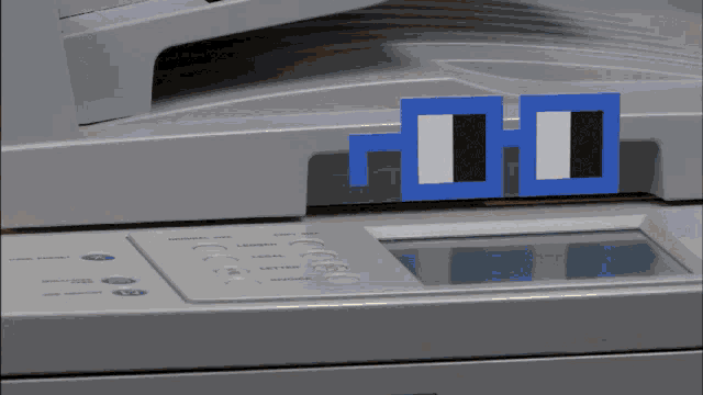 a close up of a printer with a blue and white square on it