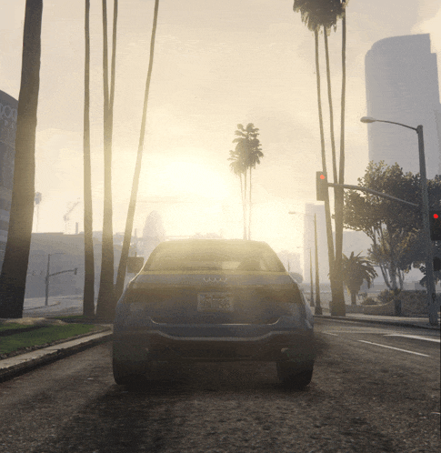 a blue audi is driving down a street with palm trees and buildings in the background