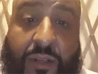 a close up of a man 's face with a beard .