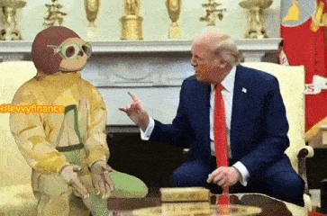 a man in a suit and tie is sitting next to a man in a monkey costume and talking to him