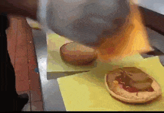 a bunch of hamburgers are sitting on a yellow cutting board