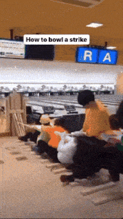 a group of people sitting in a bowling alley with the words how to bowl a strike on the bottom