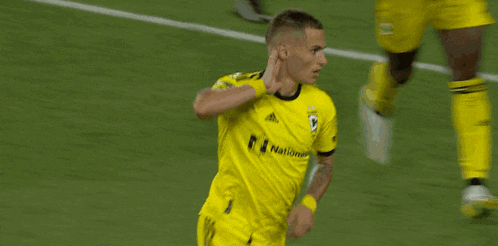 a soccer player wearing a yellow jersey with the number 9 on it