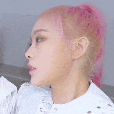 a close up of a woman 's face with pink hair and a white jacket
