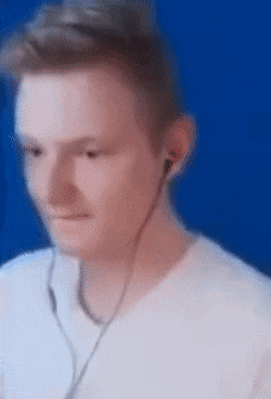 a blurry picture of a man wearing ear buds against a blue background .