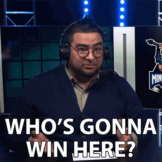 a man wearing headphones and glasses says " who 's gonna win here "