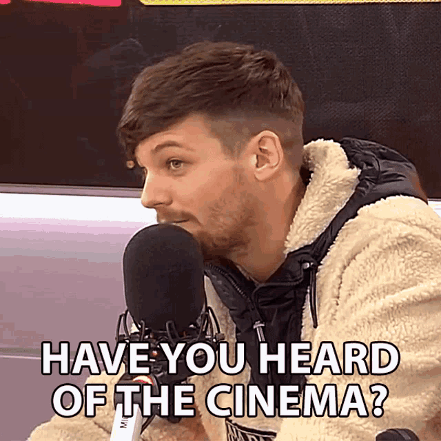 a man talking into a microphone with the words have you heard of the cinema