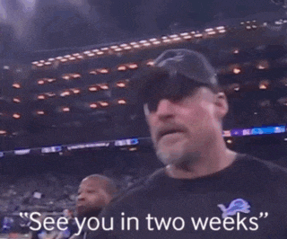 a man in a baseball cap says " see you in two weeks " in front of a crowd