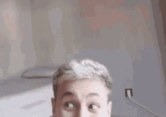 a close up of a person 's face with their mouth open and a surprised look on their face .