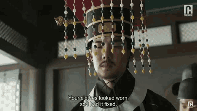 a man with a crown on his head says your clothes looked worn , so i had it fixed