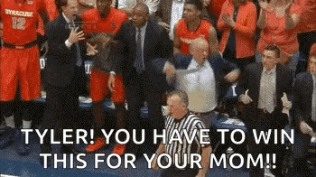 a referee is standing in front of a crowd of people while a basketball team celebrates a win .
