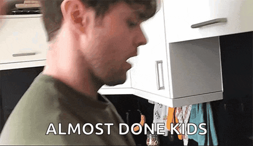 a man in a kitchen with the words " almost done kids " on the screen