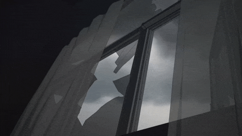 a broken window with a cloudy sky visible