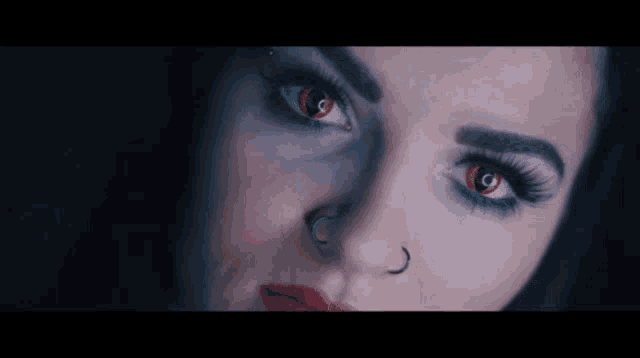 a woman with red eyes has a nose ring