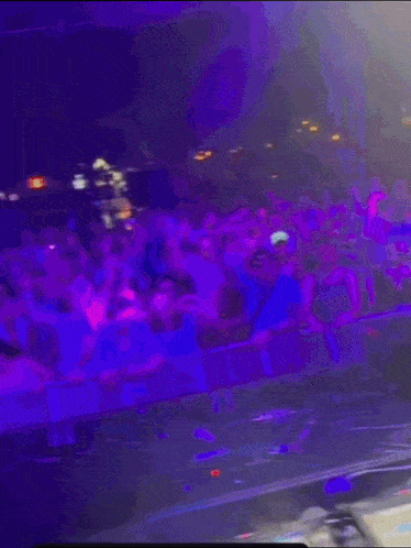 a man is playing a dj set in front of a crowd