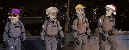 a group of ghostbusters wearing santa hats and masks .