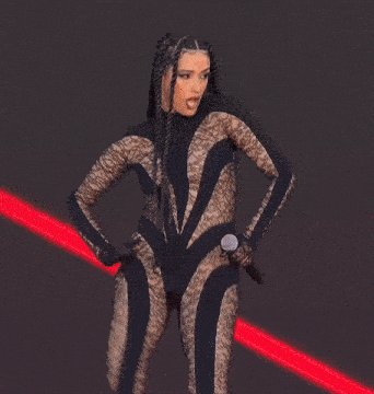 a woman in a leopard print bodysuit holds a microphone