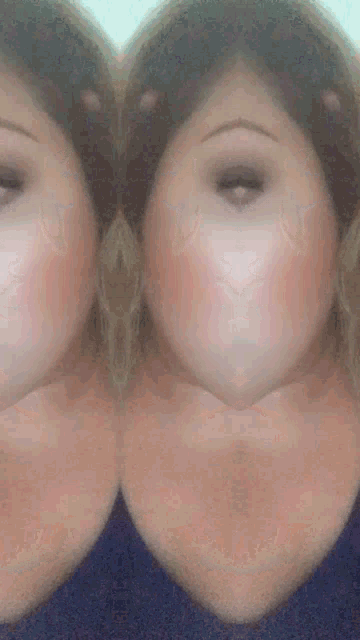 a close up of a woman 's face with a blue shirt