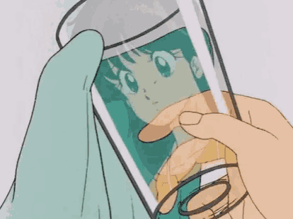 a hand is holding a glass with a picture of a girl on it .